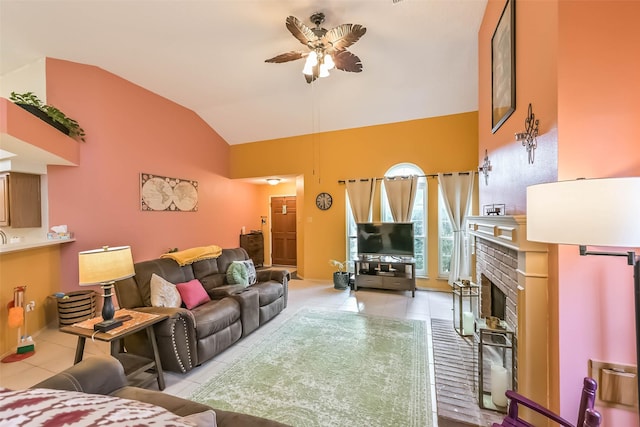 living room with light tile patterned floors, lofted ceiling, a brick fireplace, and ceiling fan