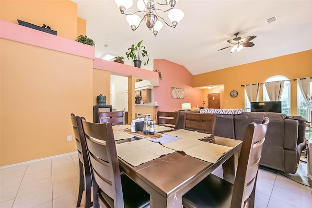 dining area with light tile patterned flooring, visible vents, ceiling fan with notable chandelier, and lofted ceiling