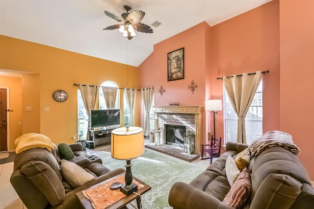 living room featuring visible vents, a brick fireplace, high vaulted ceiling, and ceiling fan