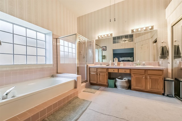 bathroom with a sink, a shower stall, wallpapered walls, double vanity, and a bath