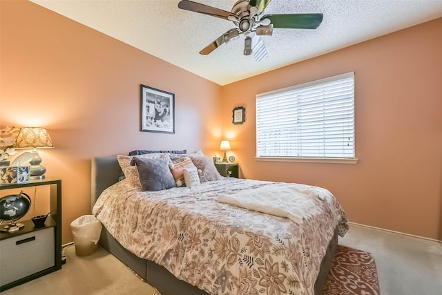 bedroom featuring carpet flooring, a ceiling fan, baseboards, and a textured ceiling