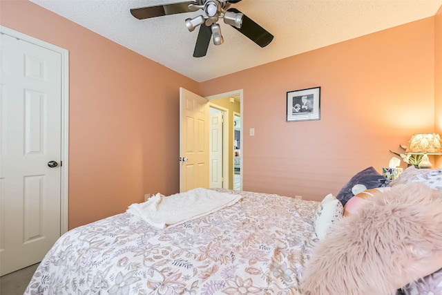 bedroom featuring a ceiling fan and a textured ceiling