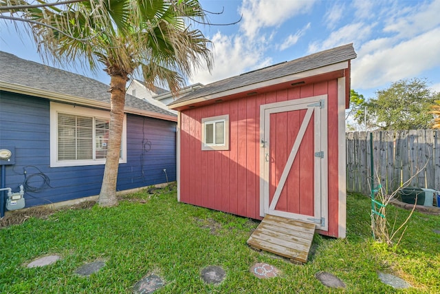 view of shed featuring fence