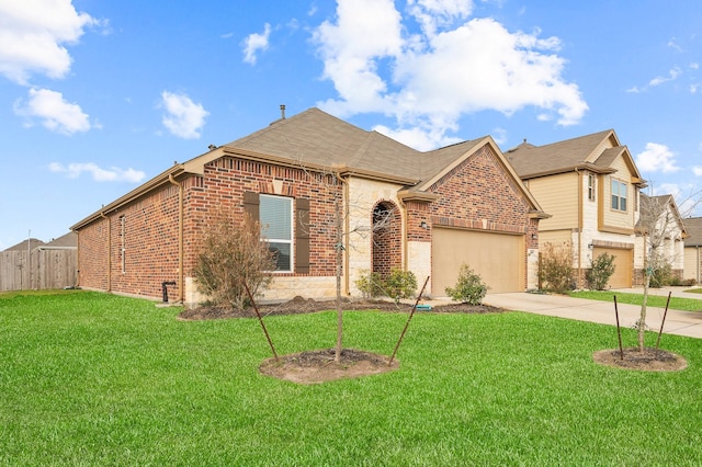 view of front of home featuring a front lawn, fence, concrete driveway, an attached garage, and brick siding