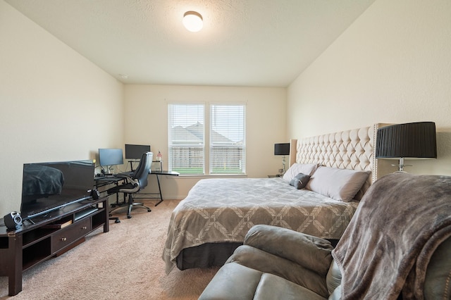 bedroom with carpet flooring and lofted ceiling