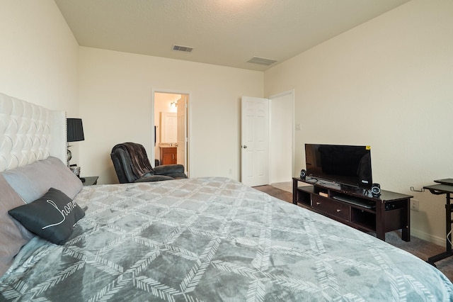 bedroom with visible vents, baseboards, and carpet