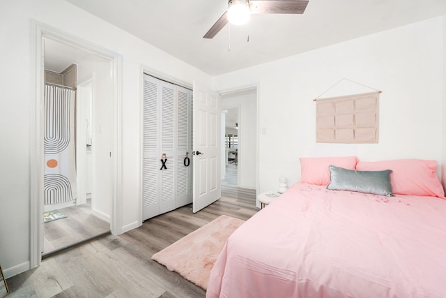 bedroom featuring a ceiling fan, wood finished floors, a closet, and baseboards