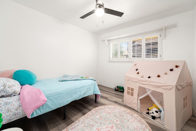 bedroom with wood finished floors and a ceiling fan