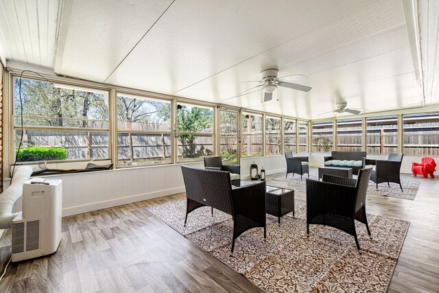 sunroom / solarium with a ceiling fan