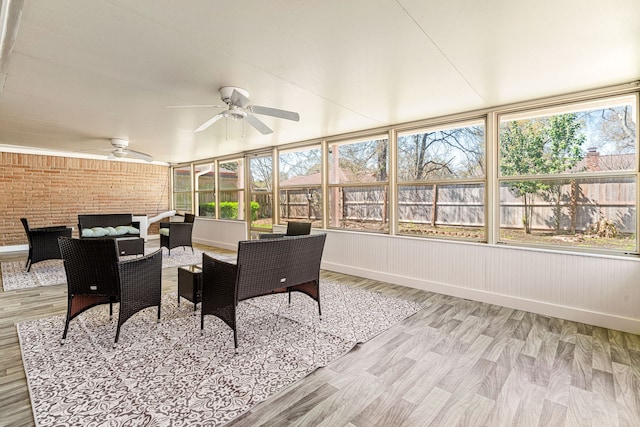 sunroom with plenty of natural light and a ceiling fan