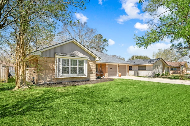 single story home featuring a garage, brick siding, concrete driveway, and a front yard