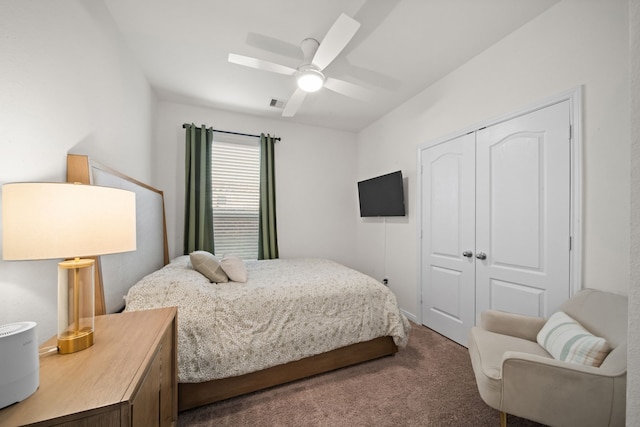 carpeted bedroom with visible vents, a closet, and ceiling fan