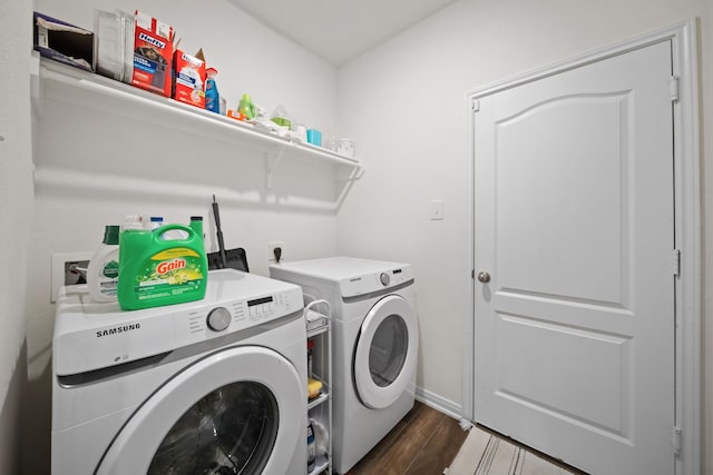 laundry area featuring baseboards, dark wood-type flooring, laundry area, and washing machine and clothes dryer