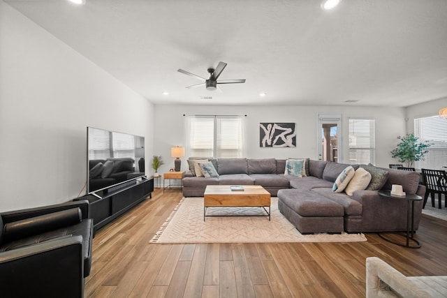 living area with light wood-style flooring, recessed lighting, a wealth of natural light, and ceiling fan