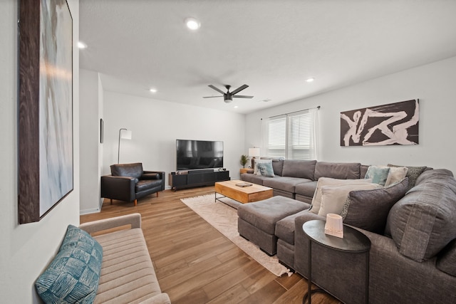 living room featuring recessed lighting, a ceiling fan, and wood finished floors