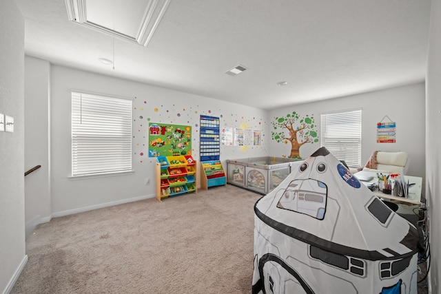 rec room with baseboards, visible vents, carpet floors, and attic access