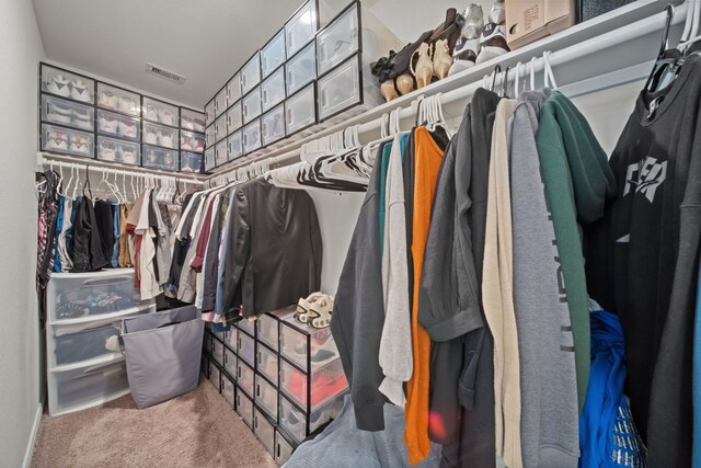 walk in closet with visible vents and carpet flooring