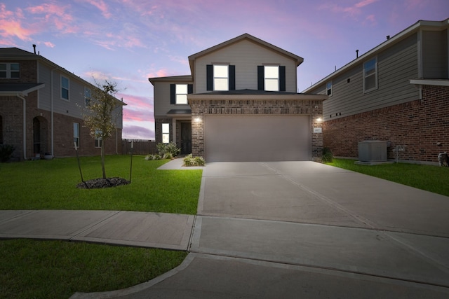 view of front of home with driveway, a front lawn, cooling unit, a garage, and brick siding