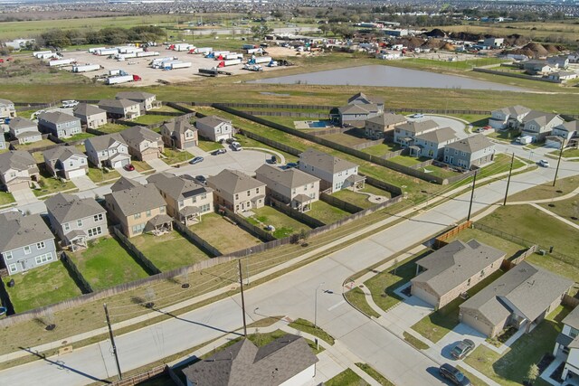 drone / aerial view with a residential view and a water view