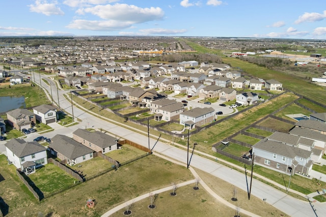 birds eye view of property with a residential view and a water view