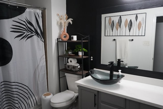 bathroom with a shower with shower curtain, toilet, and vanity