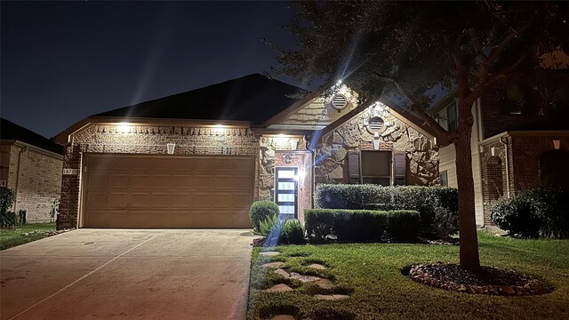 french country style house featuring brick siding, stone siding, and driveway