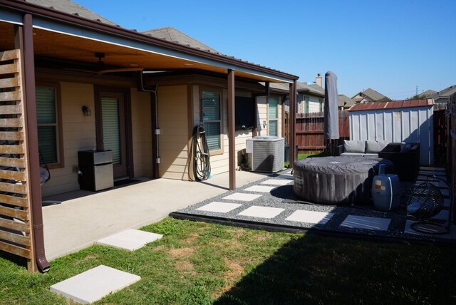 exterior space with central air condition unit, a shed, an outdoor structure, and fence