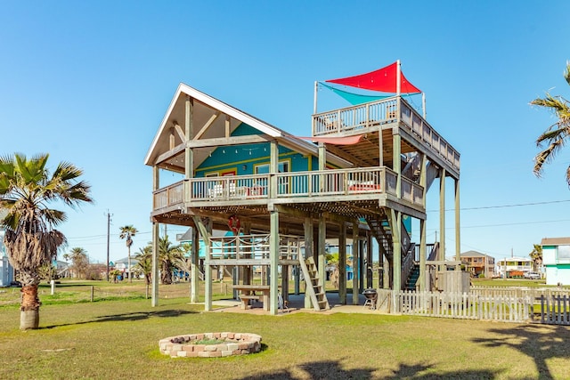 exterior space with a yard, a deck, stairs, and fence