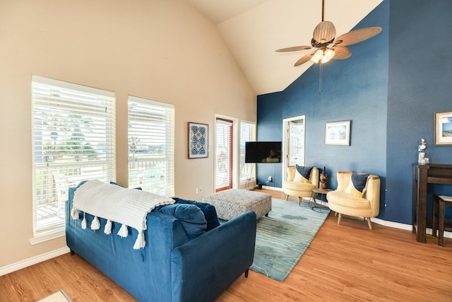 living area featuring high vaulted ceiling, wood finished floors, baseboards, and ceiling fan