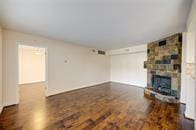 unfurnished living room featuring wood finished floors and a fireplace