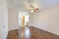 unfurnished room with ceiling fan and wood finished floors