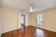 unfurnished room featuring a ceiling fan and wood finished floors