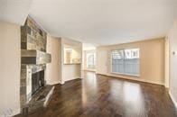 unfurnished living room with a fireplace and wood finished floors