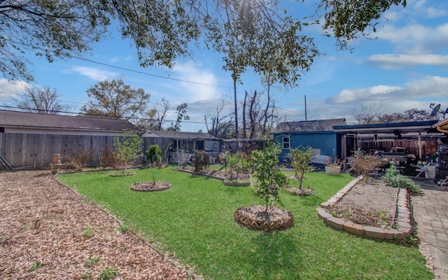 view of yard with a patio, an outdoor structure, a vegetable garden, and a fenced backyard