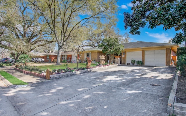 ranch-style house with brick siding, driveway, and a garage