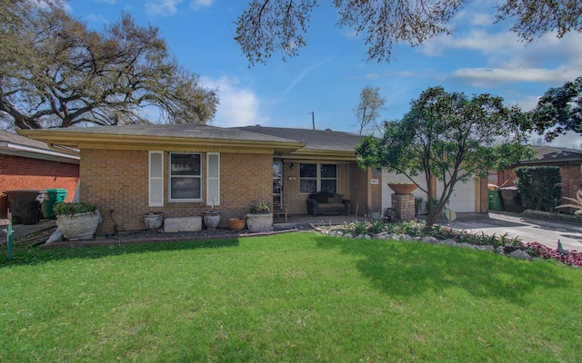 ranch-style home featuring driveway, brick siding, an attached garage, and a front yard