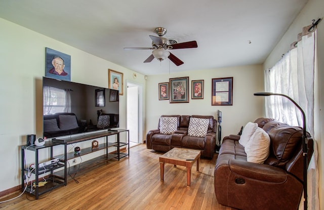 living room featuring wood finished floors and a ceiling fan