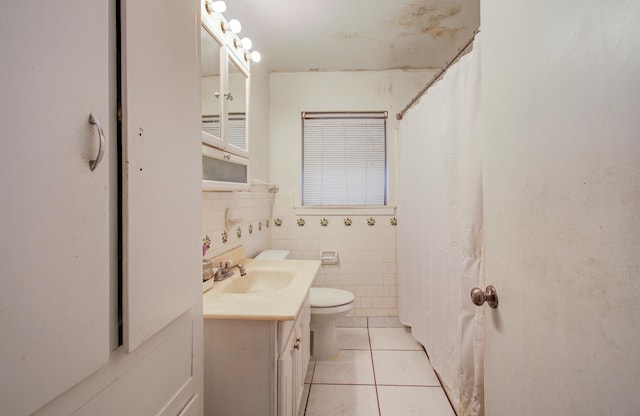 full bathroom with vanity, a shower with curtain, tile patterned flooring, tile walls, and toilet