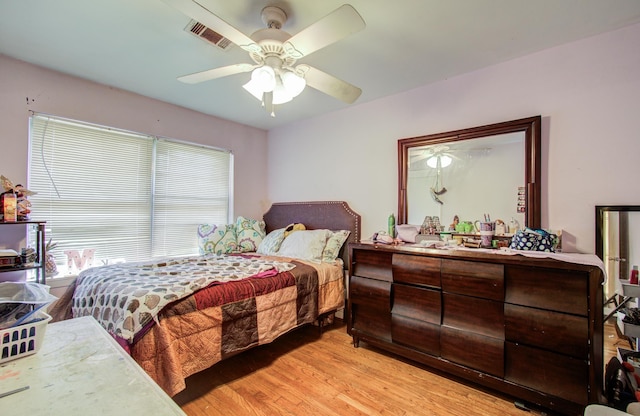 bedroom featuring ceiling fan, visible vents, and light wood-type flooring