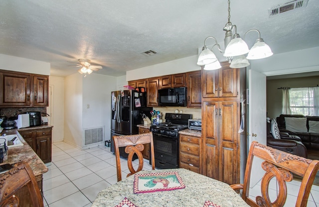 kitchen featuring tasteful backsplash, visible vents, and black appliances