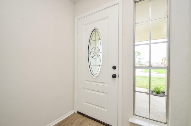 foyer with baseboards and light wood finished floors