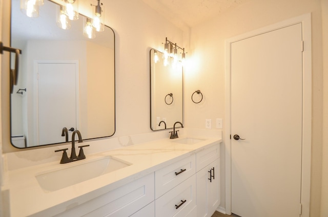 full bathroom featuring double vanity and a sink