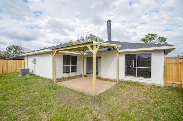 rear view of house featuring a patio area, central air condition unit, a yard, and fence