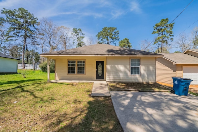 view of front of house featuring an attached garage, concrete driveway, and a front lawn