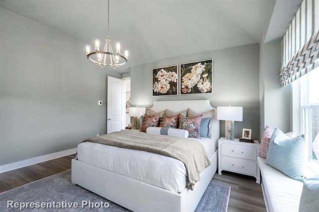 bedroom with baseboards, a notable chandelier, and wood finished floors