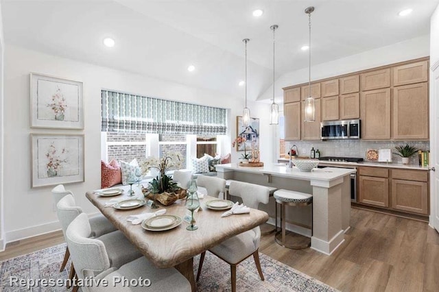 dining area with vaulted ceiling, recessed lighting, wood finished floors, and baseboards