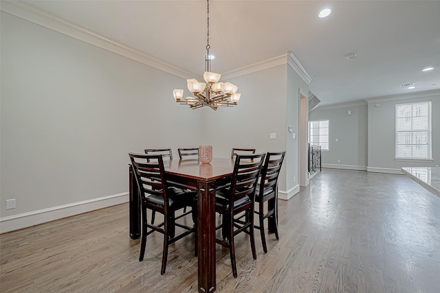 dining space featuring baseboards, plenty of natural light, and wood finished floors