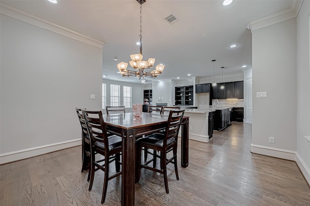 dining area with visible vents, recessed lighting, crown molding, light wood finished floors, and baseboards