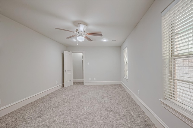 spare room with ceiling fan, recessed lighting, baseboards, and light carpet