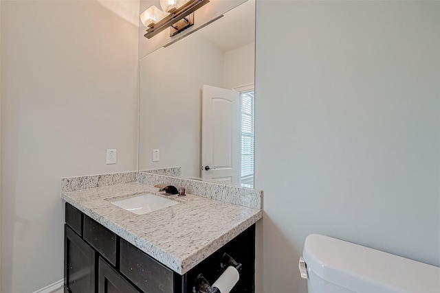 bathroom with toilet and vanity